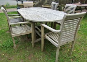 A good quality weathered teak Cotswold collection D end extending garden table with two bi-folding