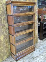 A Globe Wernicke & Co Ltd oak floorstanding five sectional library bookcase with 'up and over'