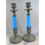 A pair of 19th century candlesticks with blue glass stems set in an ancanthus leaf base and