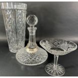 A diamond cut flat bottom ships decanter, a matching tall stemmed bowl and a tall vase