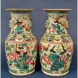 A pair of 19th century famille rose vases with hand painted detail showing birds foliage, etc,