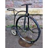 A small novelty metal garden pot stand in the form of a penny farthing bicycle, 57cm high