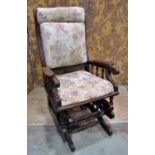 A late 19th/early 20th century walnut rocking chair with later upholstered pad seat and back