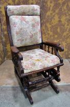 A late 19th/early 20th century walnut rocking chair with later upholstered pad seat and back