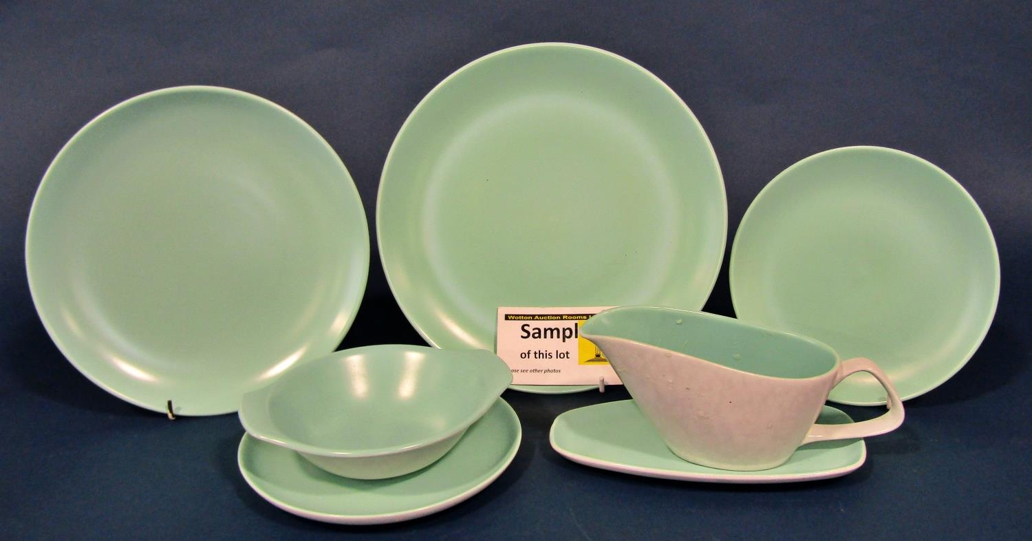 A large collection of Poole Pottery ware in green with mushroom coloured examples to include