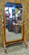 A Victorian pine cheval mirror with simple arched frame raised on chamfered swept scrolled and