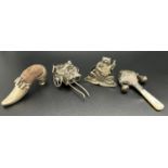 A collection of miniature silver items including a frog playing the mandolin, a menu holder, a small