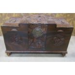 A Chinese camphor wood coffer with deeply carved landscape and character detail