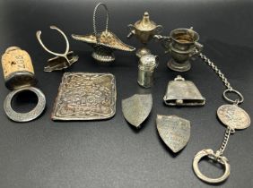 A collection of miniature silver items to include two trophies, a wicker fruit basket, wishbone menu