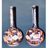 A pair of Japanese Imari vases, with bulbous bases and drawn necks, with typical decoration, 23cm