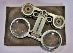 A pair of French 'Jumelles Mars' adjustable opera glasses with folding eye piece and grip complete