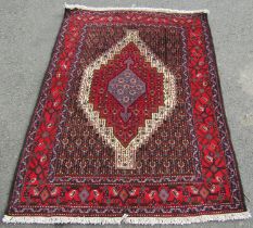 A north west Persian Senneh rug, with central stepped lozenge medallion, in blue, red and cream