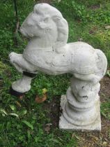 An unusual painted and weathered cast composition stone garden ornament or pier cap with rotating