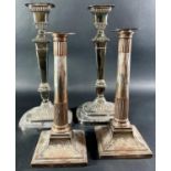 A pair of silver plated rounded square column candlesticks with gadrooned footing, 32cm high, and