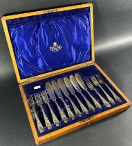 An oak box of six fish knives and forks.