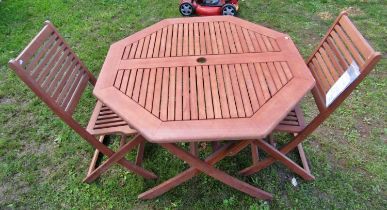 A contemporary folding hardwood garden table with octagonal slatted top, together with a pair of