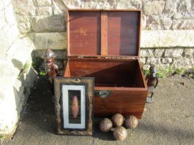 A contemporary hardwood chest with hinged lid plus contents including two carved hardwood figures,