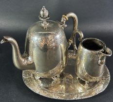 A breakfast tea service of a small silver plated engraved teapot, milk jug and a silver tray stamped