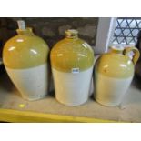 Three vintage stoneware flagons, varying capacity, two with impressed merchants marks for