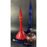 A tall Venetian red glass Genie vase, hollow stopper, 57cm tall, similar blue Genie vase, a Murano