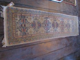 An eastern wool rug with beige ground, seven medallion centre within simple running borders, 280cm x