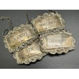 four matching silver drinks labels with shell and garland scrolling decoration, Gin, Sherry, Whiskey