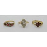 Three 9ct rings comprising two garnet examples and a marquise shaped white stone example, 5.8g