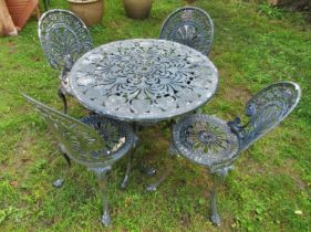 A weathered green painted five piece cast aluminium garden terrace set with decorative pierced