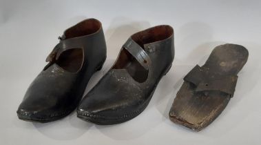 A pair of late 19th / early 20th century British clogs comprising a black leather upper over a