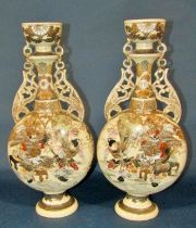 A pair of decorative early 20th century Japanese satsuma export vases of moonflask form with pierced