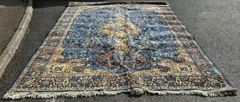 A Sarouk carpet with a central floral medallion and an over all floral pattern on a blue ground, 360
