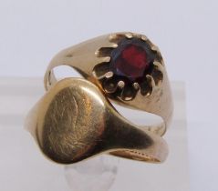 Two gents 9ct rings; a signet ring and a claw set garnet example, both size X, 7.1g total