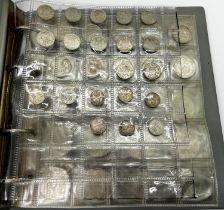 An album containing a collection of pre1947 silver coinage to include Victorian and later crowns,