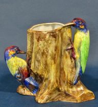 Three Radford pottery vases decorated with five woodpeckers together with a further model bird, a