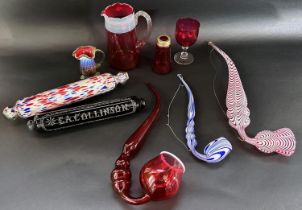 Victorian novelty glassware including a cranberry glass pipe, a Nailsea red glass pipe,