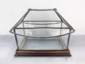 A glass and lead terrarium with a traditional pitched roof lid, set on a wooden base, 33cm wide.