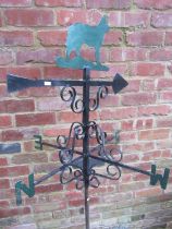 A partially painted weather vane, topped with finial in the form of a dog, 78cm high