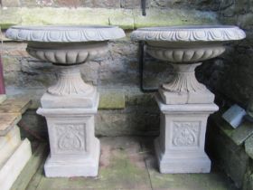 A pair of classical design cast composition stone garden urns, the squat shallow lobbed bowls with