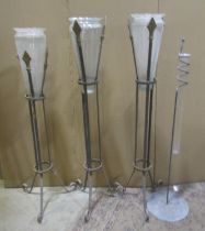 Four assorted floor standing ironwork flower arranging vase holders with glass vases together with