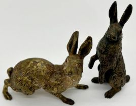 Two cold painted old bronze figures of hares, one upright, one on all fours, 6cm long and high