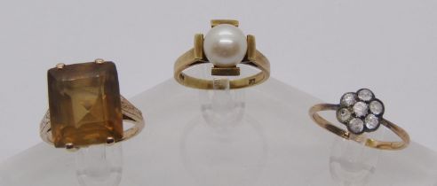 Three vintage dress rings comprising a yellow metal citrine example, a 9ct pearl example and a