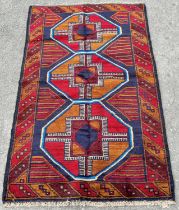 A new Baluchi carpet, with large elephant foot gul in tones of red and orange, 142cm x 89cm