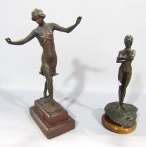 A small bronzed statue of Isadora Duncan, her name engraved below her feet, raised on a double