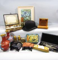 A miscellaneous collection of items to include two red cloisonné vases, a bowler hat, a damaskan