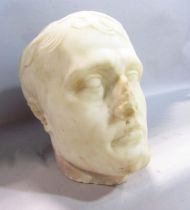 A classically carved life-size white marble head of a man, possibly Napoleon Bonepart, damage to