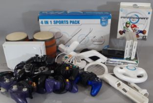 A boxful of Wii and Nintendo items including Wii MarioKart, Wii Sports Packs, Nintendo DS Lite