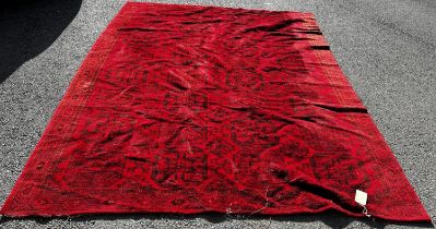 A large Turkoman carpet with four rows of elephant foot guls on a predominantly red ground