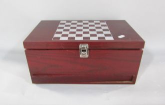 A presentation chess board containing two bottles of wine, a chess set and a swing drawer with a