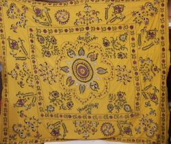 Large Suzani panel with embroidered floral stems surrounding a central circular motif, on saffron