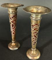 A pair of small Art Nouveau silver flower vases, Chester 1907, maker Martin Hall & Co, both with red